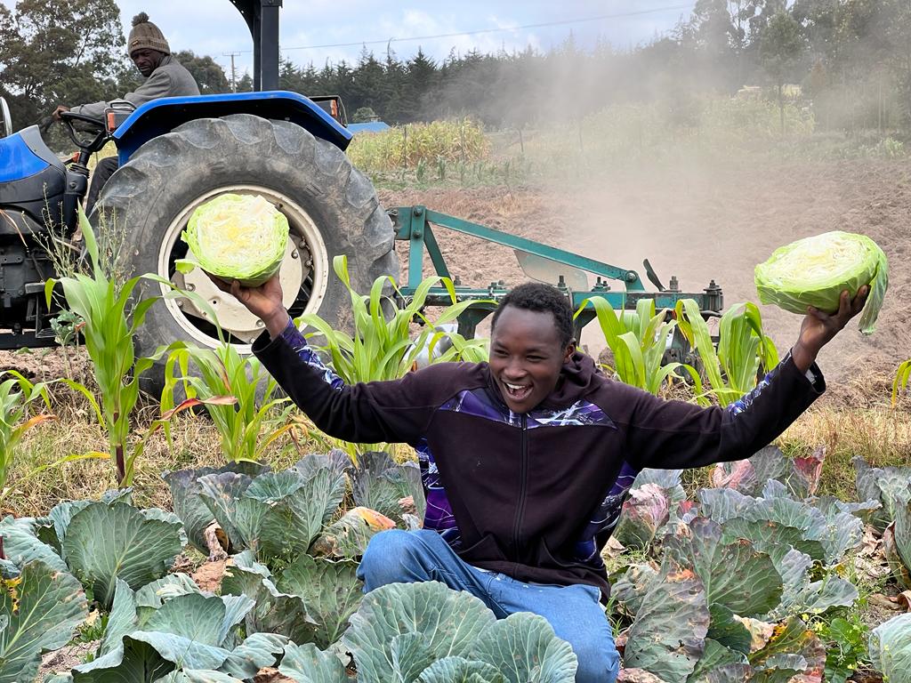 A smallholder farmer happy with his improved cabbage yield